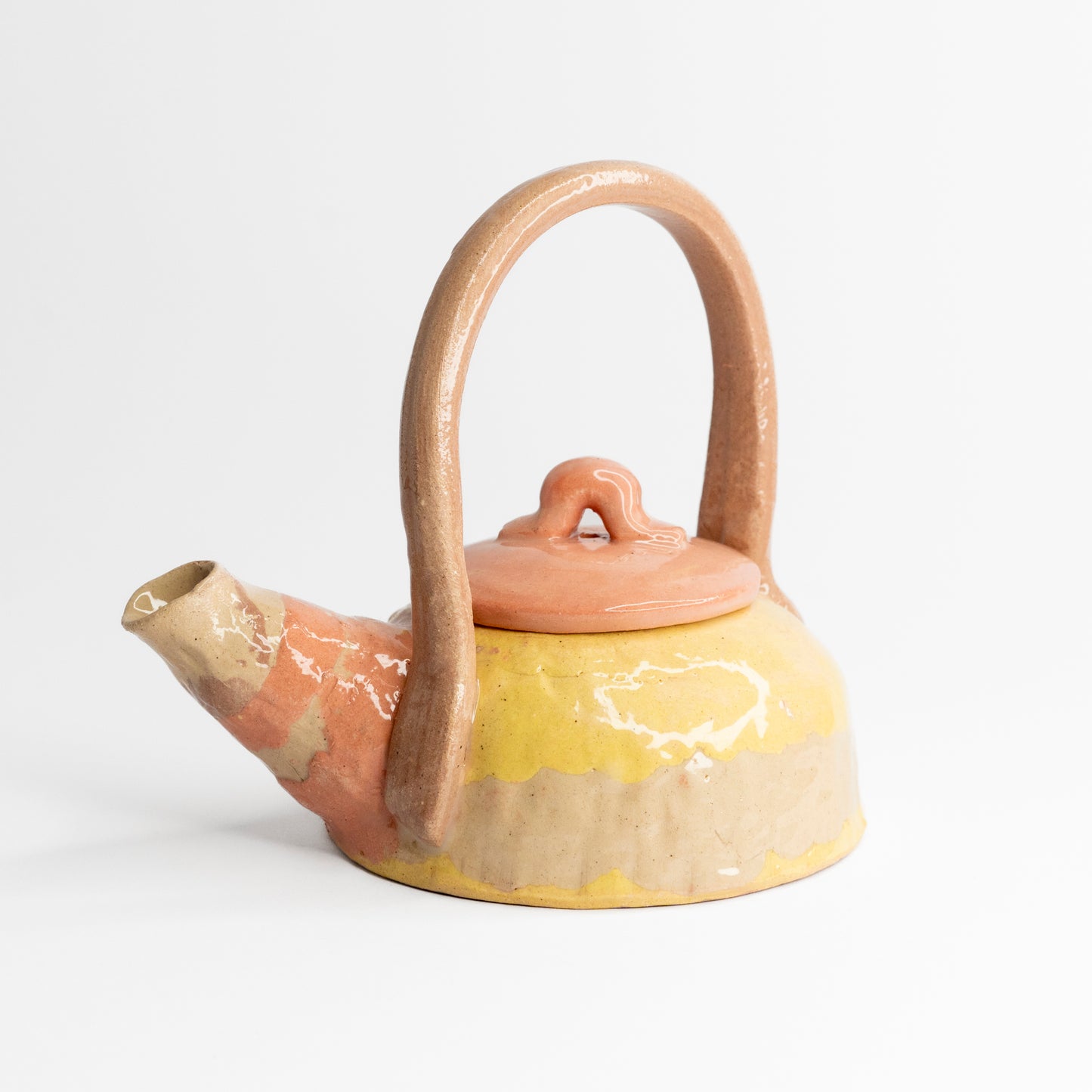 Pink and yellow coloured clay teapot