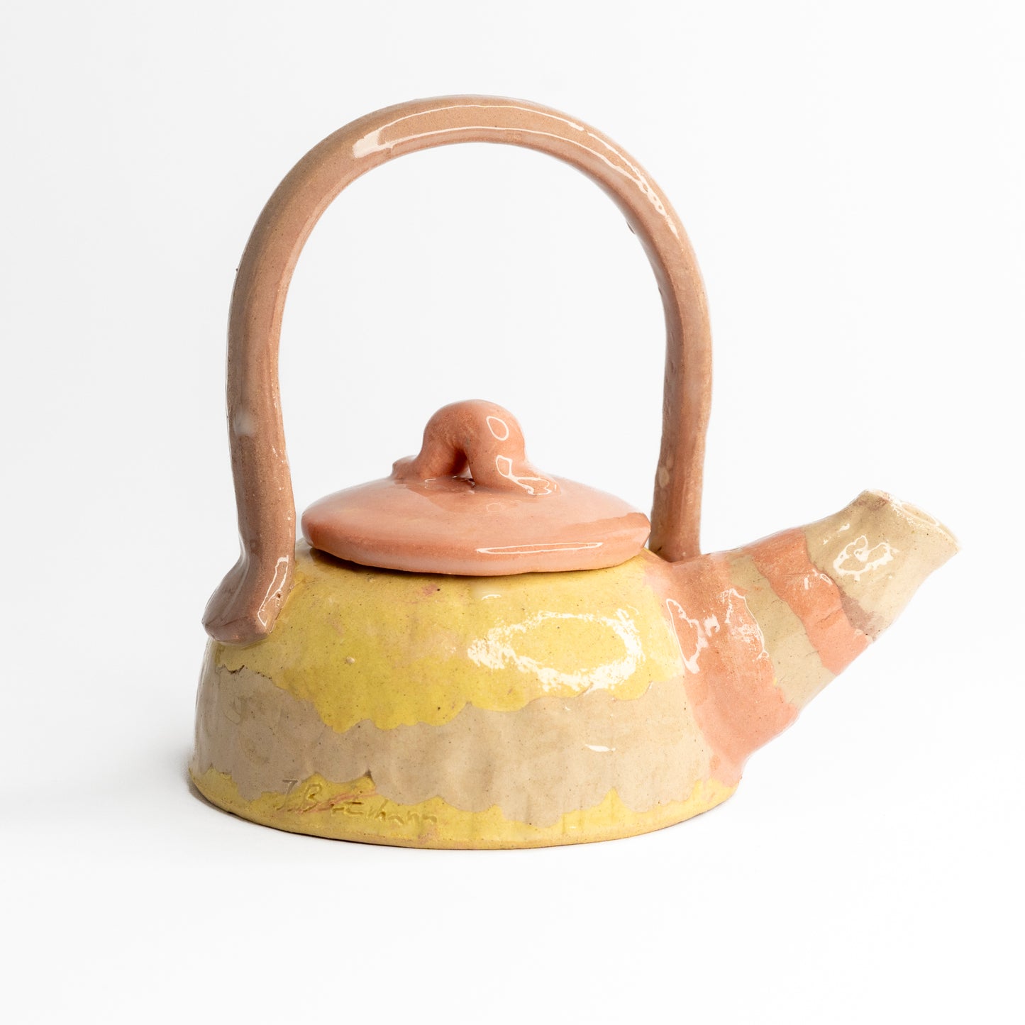 Pink and yellow coloured clay teapot